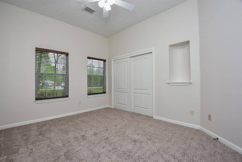 Generous carpeted floors and natural light fill a secondary bedroom; any of which may be used for specific purposes, such as a nursery, office, computer room? You decide! (Note another delightful detail, right. A charming wall niche.)