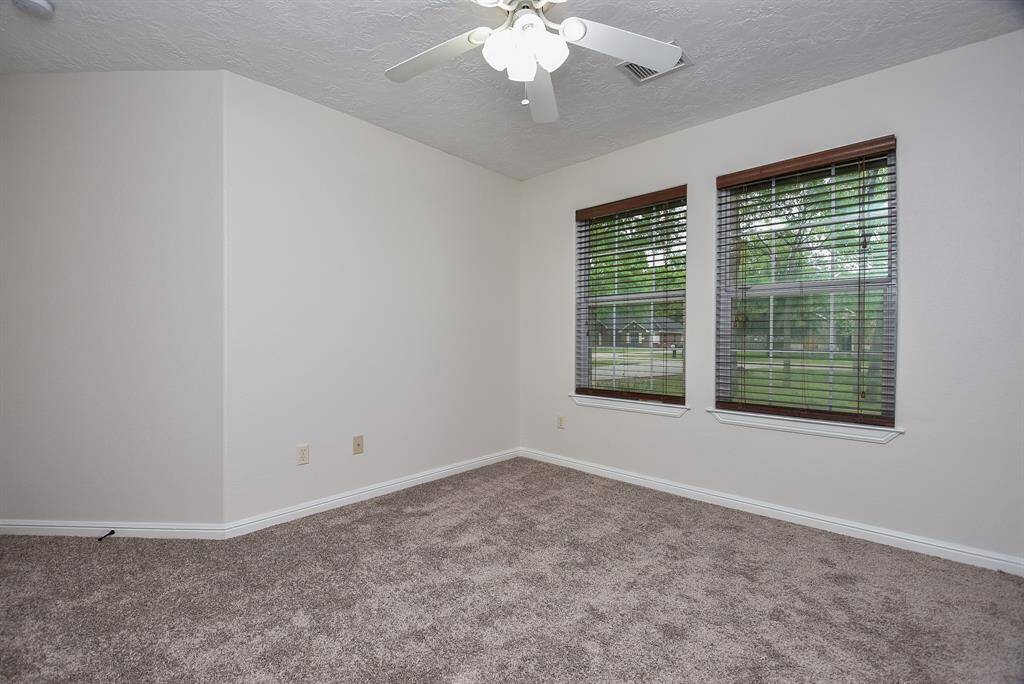 Here's another secondary bedroom, with great big windows and lots of light. (More fun details? Lacy, dentil detail on the bottom of the window frames.)