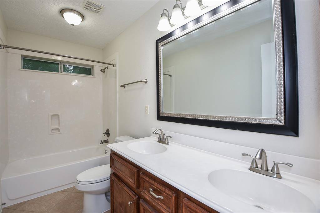 This bright full second bath combines shower and bathtub for easy options.