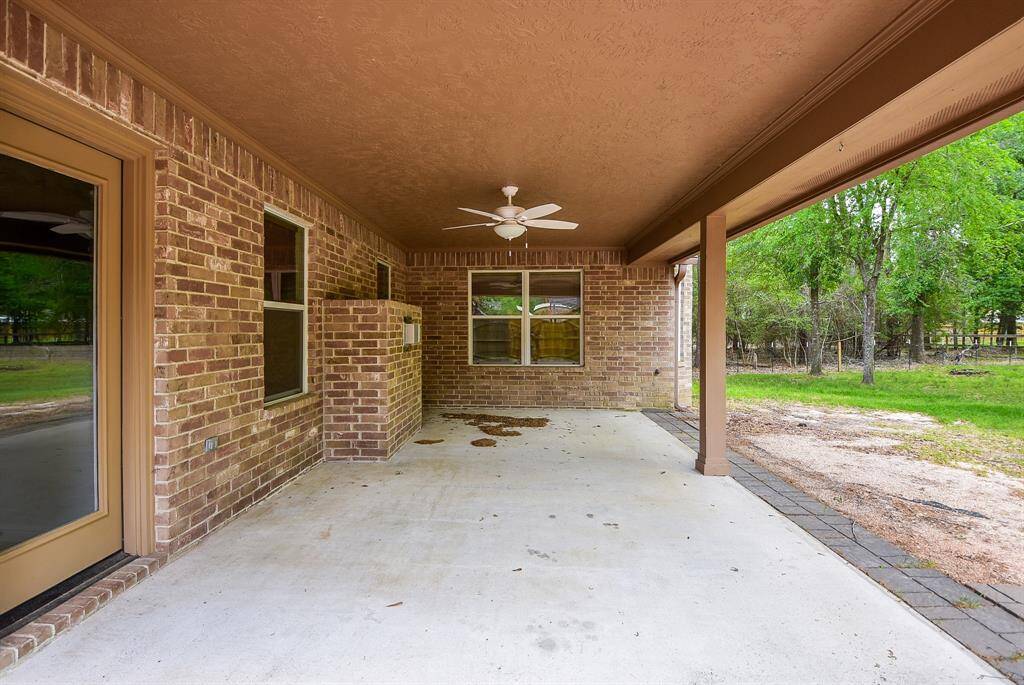 This huge, brick lined, covered patio is just begging for some summer entertaining in this natural woodland!