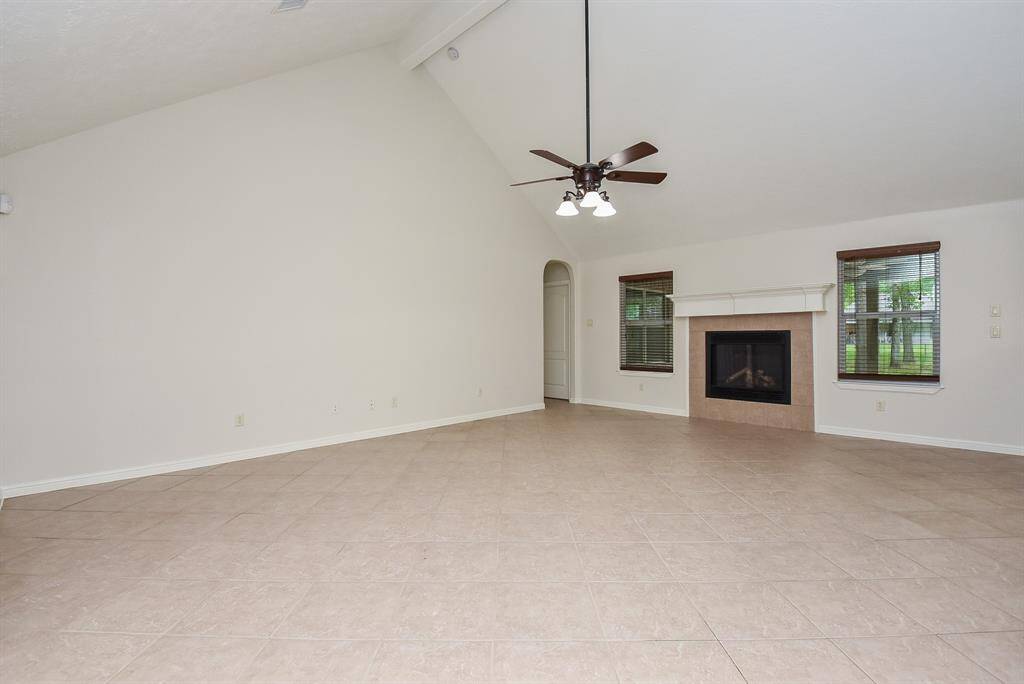 Just look at this magnificent living/family space, with its stone encased fireplace and mantle as a winning focal point! The heavenly high ceiling embraces tremendous room for relaxing and entertaining.