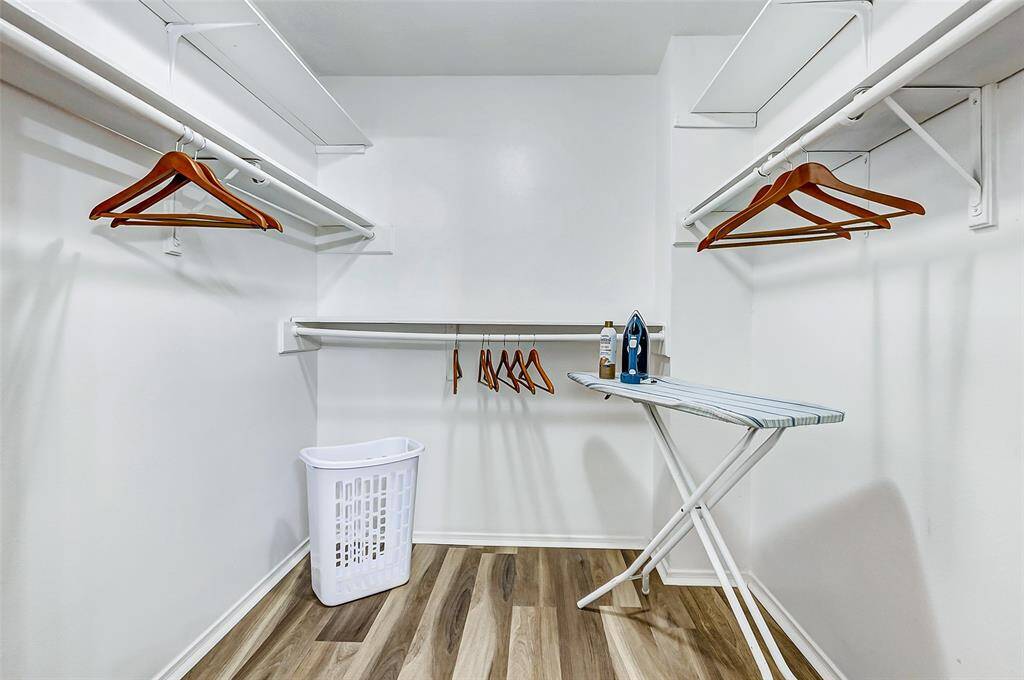Spacious primary closet with ample storage and shelving, perfect for organizing your wardrobe effortlessly.