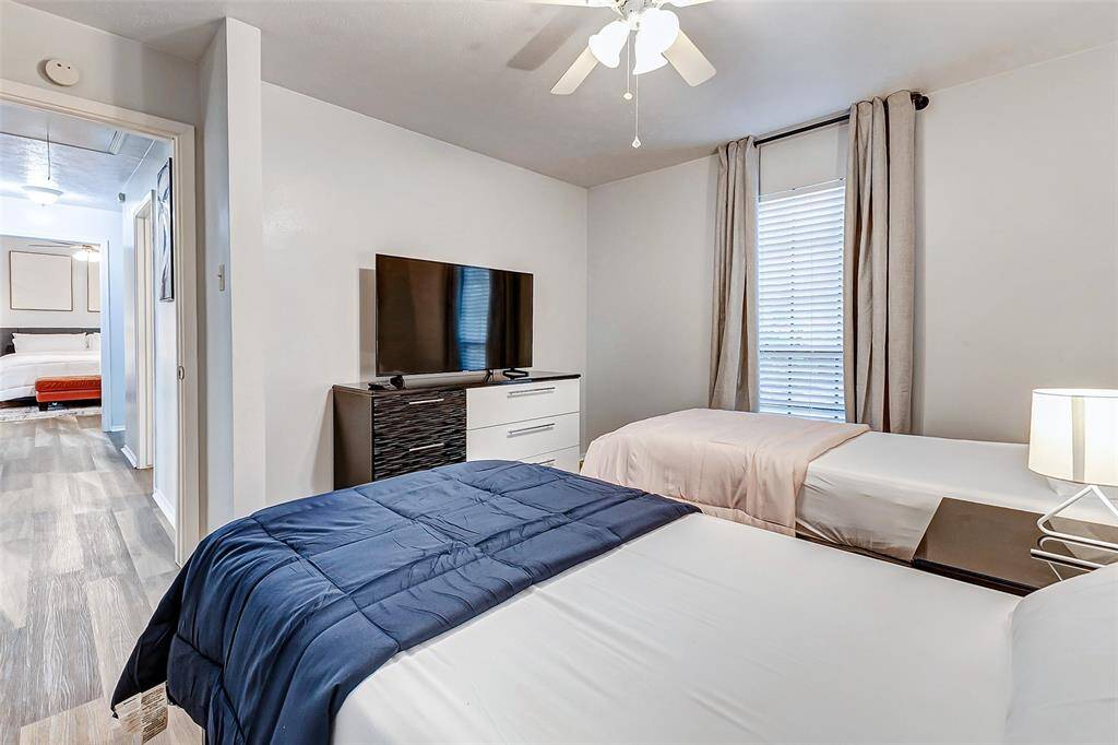 Cozy and inviting, this third bedroom boasts ample natural light, modern flooring, and a sleek ceiling fan for comfort and style. Perfect for relaxation or hosting guests.