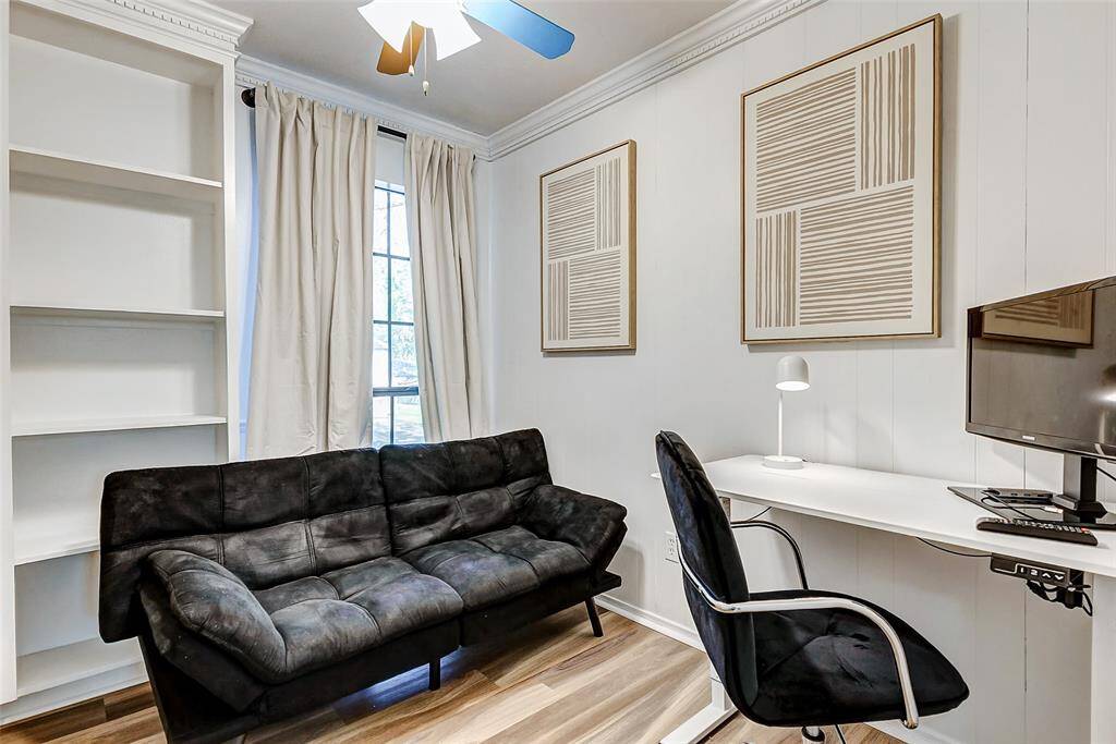 Cozy and versatile fourth bedroom featuring built-in shelves and a closet, large window for natural light, and a flexible layout perfect for a home office or guest space.