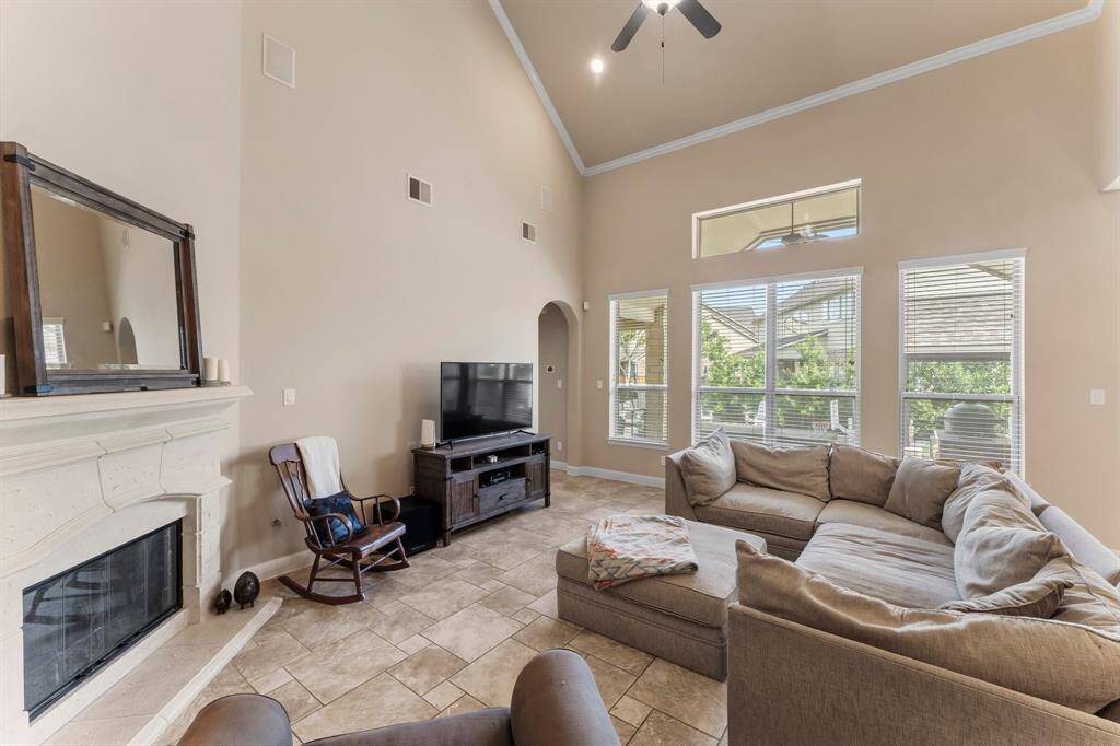 Relax and unwind in this warm and welcoming Family Room, where four sunny windows and an additional clerestory window above frame breathtaking views of the spacious backyard, covered porch, gazebo with fireplace, and salt-water pool/spa.