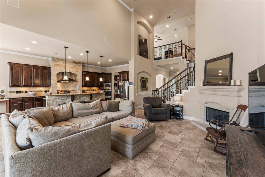 Stunning sight lines and masterful design define this breathtaking home. The two-story ceilings are carried throughout the home, creating an expansive feeling.  The open floor plan offers effortless entertaining and everyday living, making it as inviting as it is impressive. Every detail has been carefully curated to create a home that simply takes your breath away — a true showcase of timeless design and sophisticated style with an open floor plan sure to please both family and guests alike.
