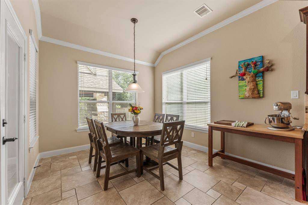 Panoramic pool views from this roomy breakfast nook! This large space is adjacent to the kitchen and is lined in windows that give an awesome view of the backyard. The backyard, pool, covered porch, and gazebo are easily accessed from this area to make outdoor entertaining a breeze!