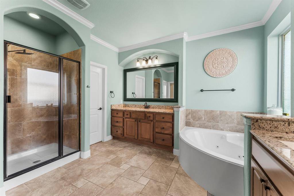 Unwind in the elegantly designed, spa-inspired Owners’ bath. Start your day refreshed with a spacious tiled shower featuring a soothing rain shower head and a convenient handheld sprayer. In the evenings, sink into the jetted tub for the ultimate relaxation experience.
