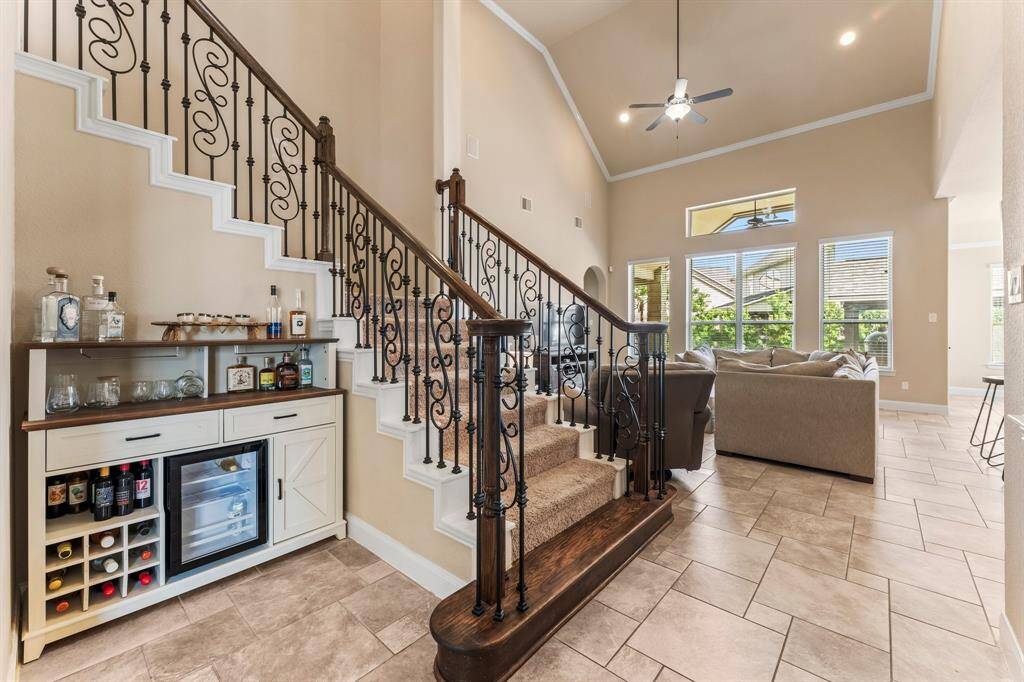 The staircase with iron balusters is centrally located in the home for family convenience. Upstairs, you will discover a spacious Game Room, Media/Exercise Room, three bedrooms, and two full baths.