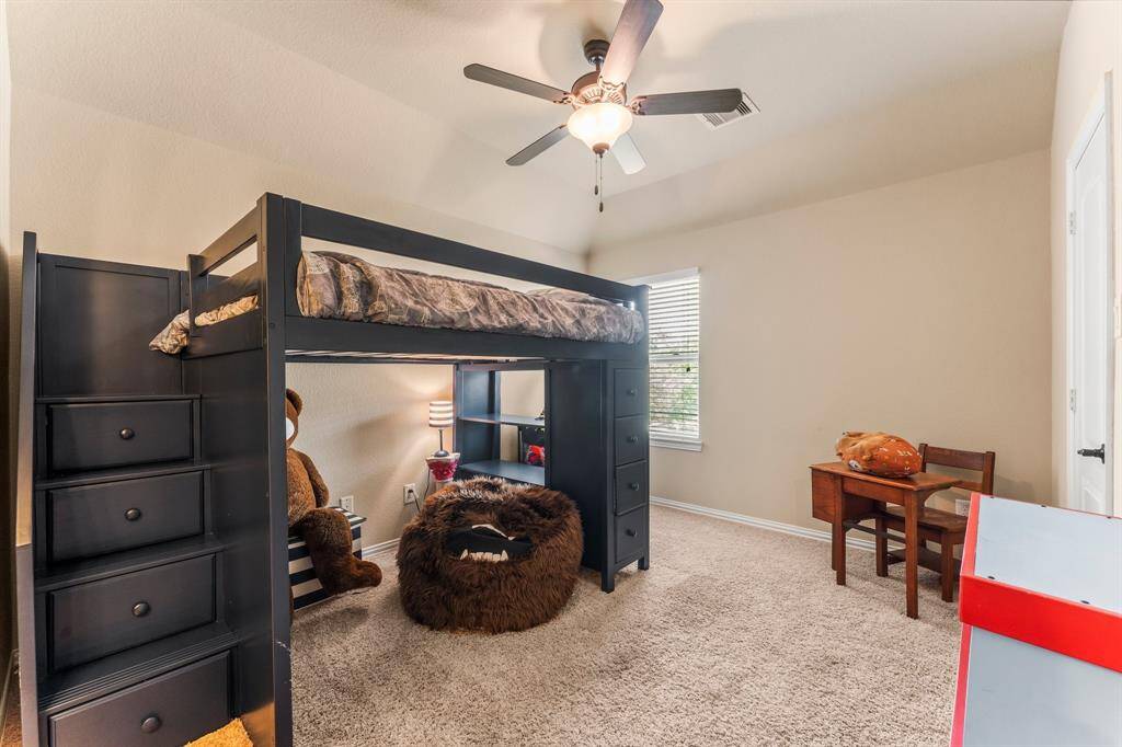Another secondary bedroom offers  lush carpeting, sloped ceiling, large walk-in closet, sunny window with blinds, and lighted ceiling fan. It has direct access to a Jack-and-Jill bath shared with Bedroom 3.