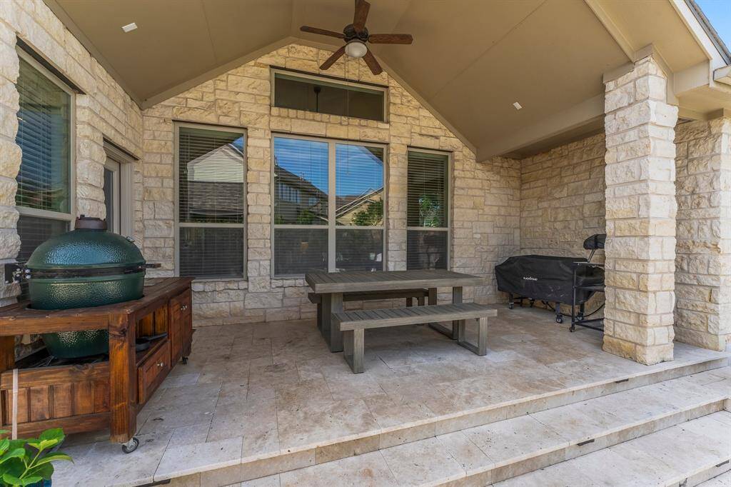 This beautifully designed covered patio is the perfect spot to unwind — whether enjoying a glass of wine, grilling dinner, or watching the kids play in the pool. It features travertine flooring, room for several grills, surround sound speaker wiring, and a lighted ceiling fan. A nearby recently added gazebo with fireplace offers additional space for dining and entertaining.