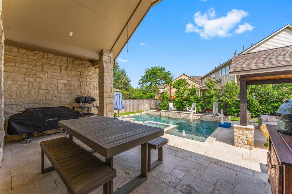 This outdoor oasis is perfect for unwinding! Lounge while waiting on the grill, sipping a cold beverage, and soaking in breathtaking sunsets. After a long day, retreat to your gazebo to enjoy a warm fire, listen to the soothing waterfall features, relax in the hot tub, or take a refreshing swim. Click the movie reel icon to view a virtual walk-through tour of this incredible back yard!