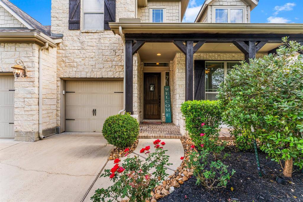 This home's striking beauty is evident the moment you arrive. Beautiful landscaping with blooming flowers, a darling front porch with rustic pillars and coordinating wood shutters, and patina coach lights add a lot of charm to this wonderful home!