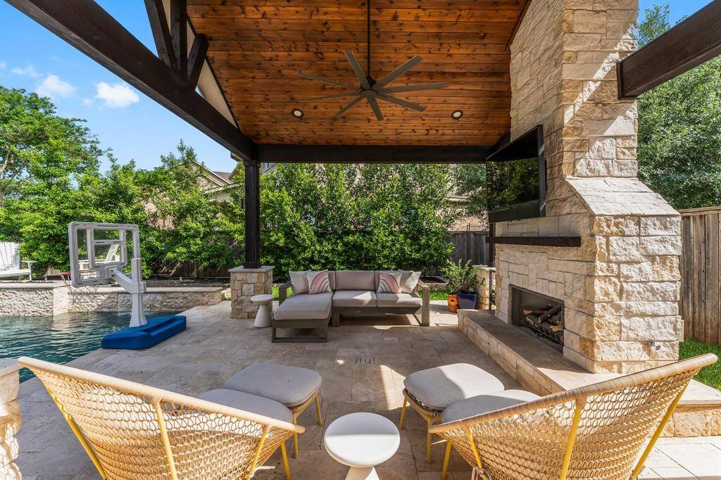 This stunning gazebo is the ultimate outdoor retreat, featuring a rich wood vaulted ceiling, recessed lighting, and a ceiling fan for year-round comfort. Whether you're hosting a cozy evening gathering or enjoying a quiet moment by the stone fireplace with gas logs, this space offers the perfect blend of charm and functionality. Ideal for entertaining, dining al fresco, or simply unwinding under the stars.