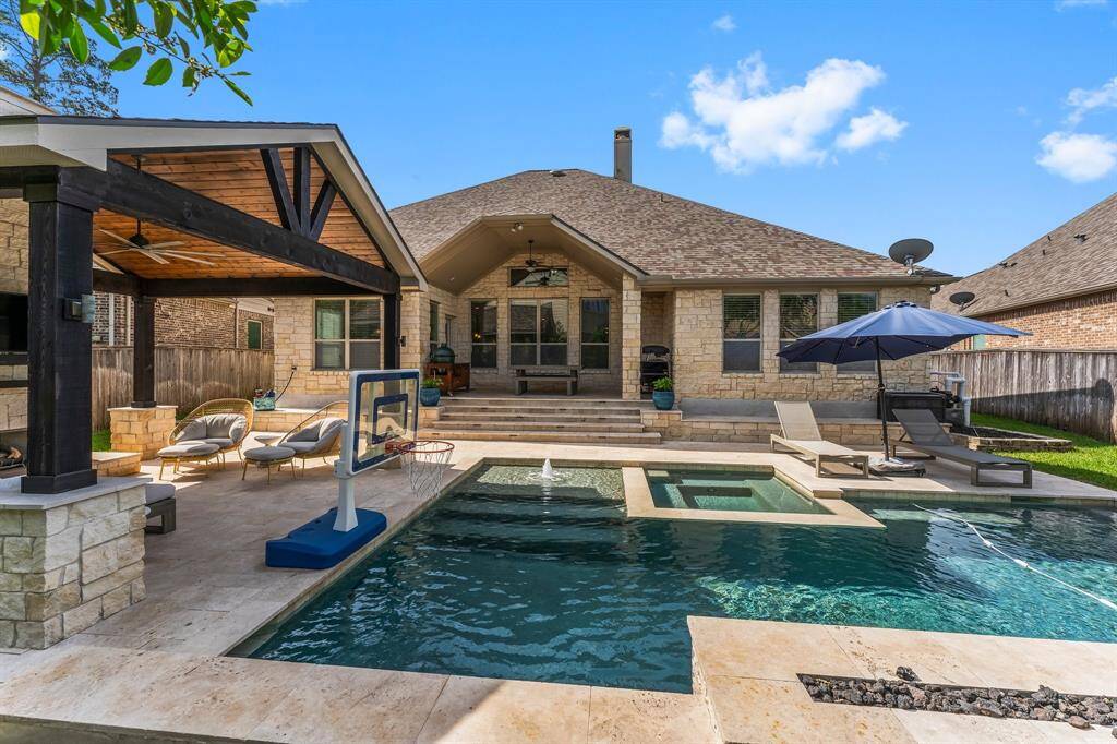 Dive into fun and relaxation with this resort-style saltwater pool, designed for every kind of enjoyment. Challenge friends to a game of basketball (hoop negotiable), unwind in the soothing hot tub, or soak up the sun on the Baja shelf complete with a bubbling water feature. Three elegant stone waterfalls create a calming ambiance, while the dramatic fire feature adds a touch of evening magic. It’s your personal backyard oasis—perfect for play, peace, and everything in between.