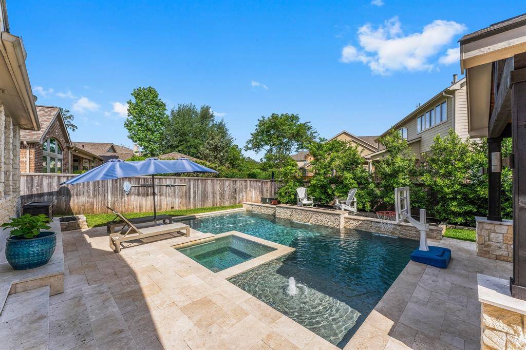 Just what the doctor ordered for perfect spring afternoons and endless summer fun! This stunning salt-water pool and spa features three stone waterfalls, a fire bowl feature, a baja shelf with soothing bubblers, and plenty of deck space for lounging. Towering trees provide privacy, creating a true backyard retreat.