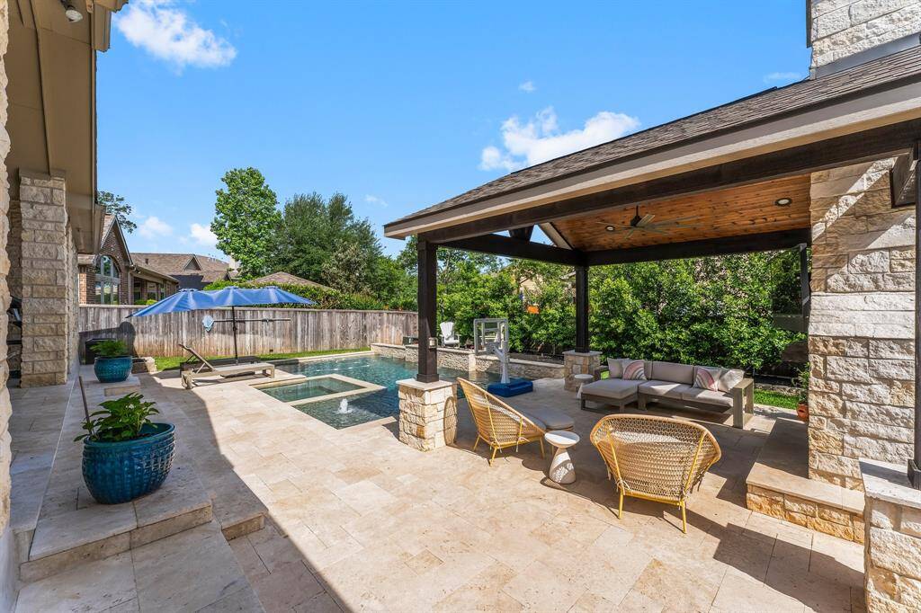 Imagine ending a long day in your own private paradise. Unwind on the covered patio as the soothing sounds of your personal waterfall melt the stress away. Take a relaxing soak in the hot tub, cozy up by the outdoor fireplace, or enjoy a few refreshing laps in the pool—pure bliss awaits just steps from your door.