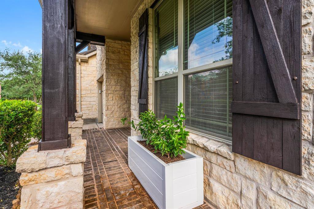 Guests are welcomed by a charming front porch featuring classic brick flooring and plenty of space for a cozy bistro set. It’s the perfect spot to relax with a glass of sweet tea while enjoying the friendly neighborhood atmosphere.