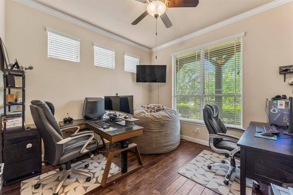 This executive office is a true standout, filled with natural light from two large windows and three clerestory windows. Elegant wood flooring, crown molding, and a lighted ceiling fan add a touch of sophistication and comfort. Glass-front French doors provide the privacy and sound control you need at times while still letting you view the activities within the home. Click the movie reel icon to view a virtual walk-through tour of this amazing home!