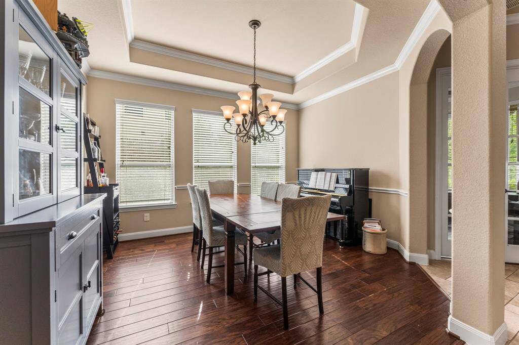 Dine in elegance in this stunning Formal Dining Room, where arched entryways and beautiful moldings create the perfect ambiance for entertaining. Whether hosting a dinner party or enjoying a quiet meal, this space adds a touch of luxury to every occasion.