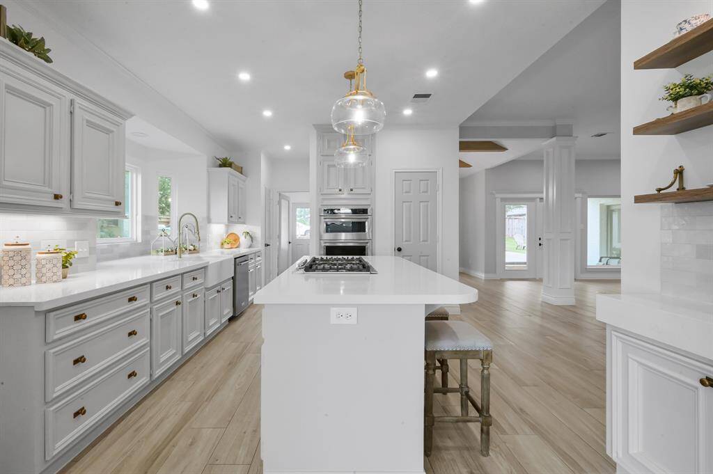 Elegantly appointed kitchen with quartz countertops and all new lighting.