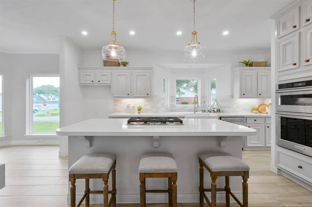 Plenty of cabinet space - Be sure to hunt for the trash can drawer during your tour! Note the glass laundry door which brings in natural light in the afternoons.
