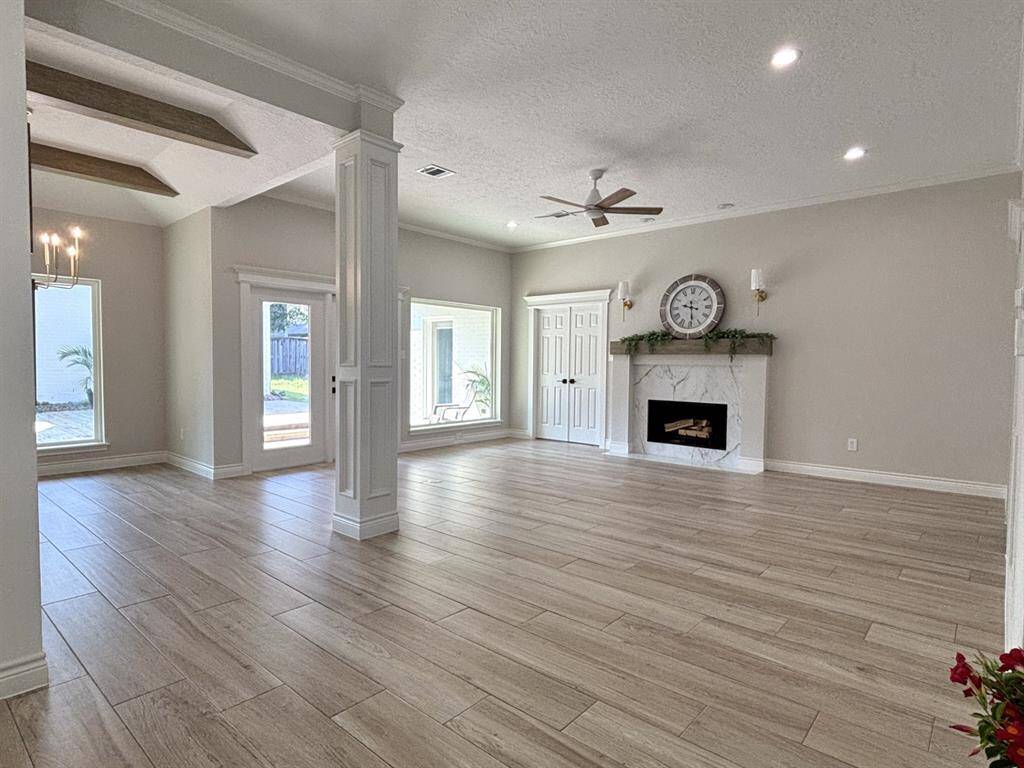 Double doors lead to the spacious primary bedroom. Primary bedroom also has a private door to the back patio.