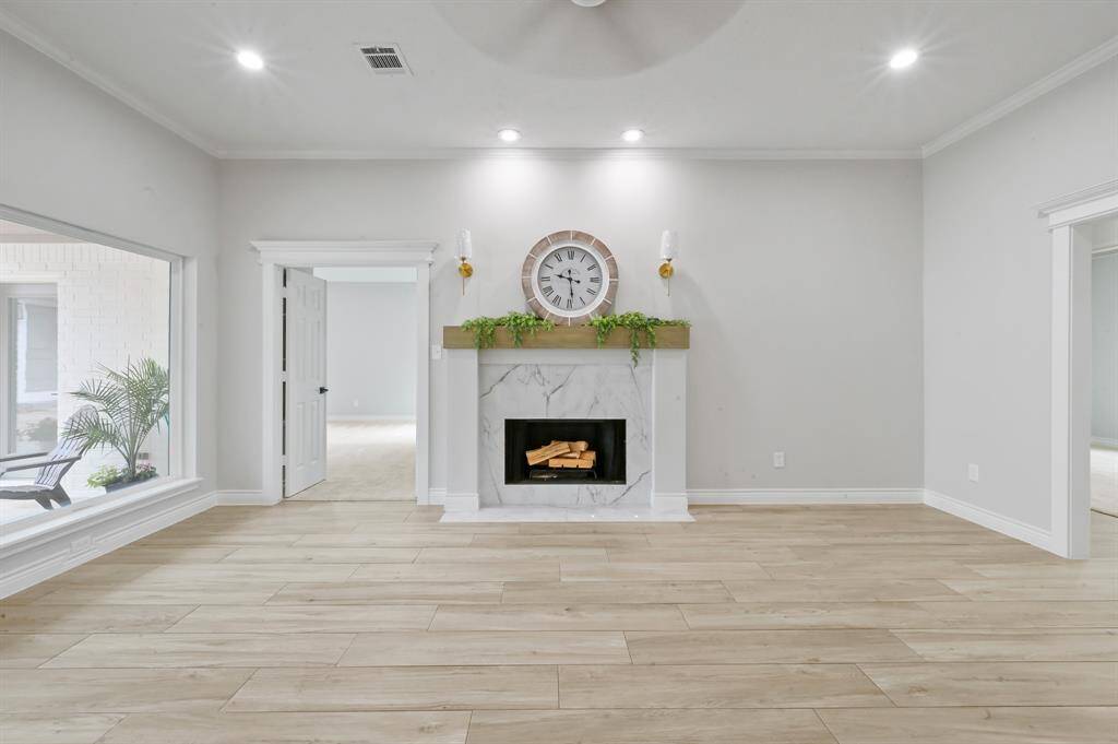 The primary bedroom has been redone with new, velvety soft carpeting, recessed lights, and two walk-in closets that provide ample storage. It is now a truly restful space.