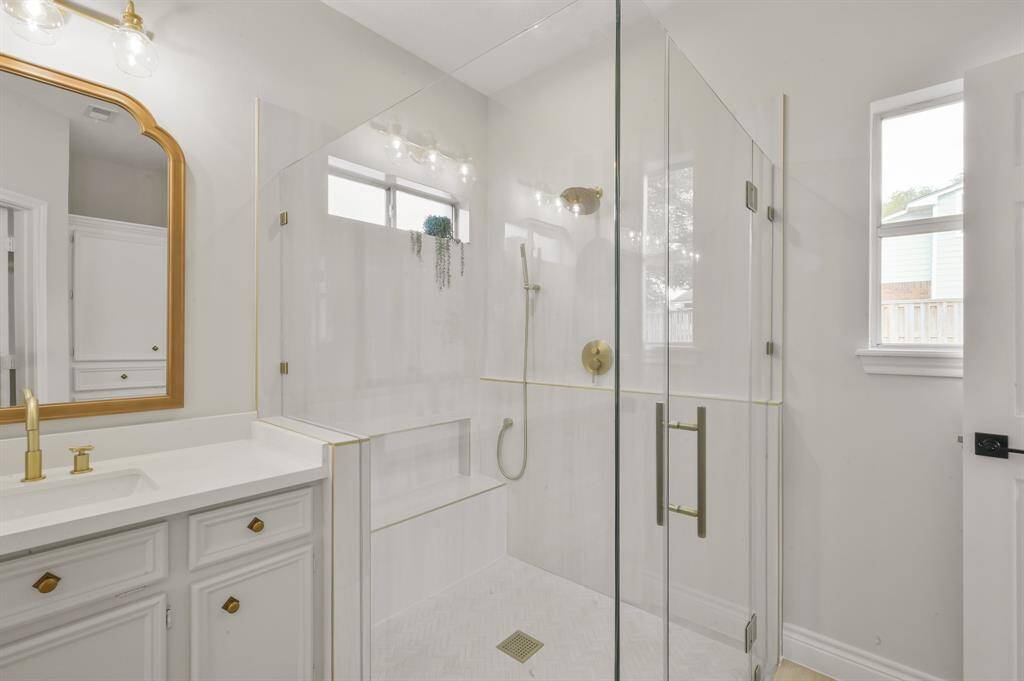 Oversized shower featuring frameless glass and curb-less entry, perfect for anyone in a chair or walker.