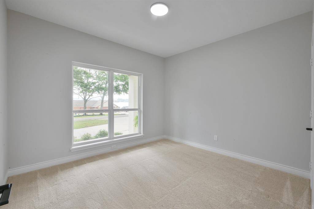 The soft, neutral color palette continues into the hall bathroom.