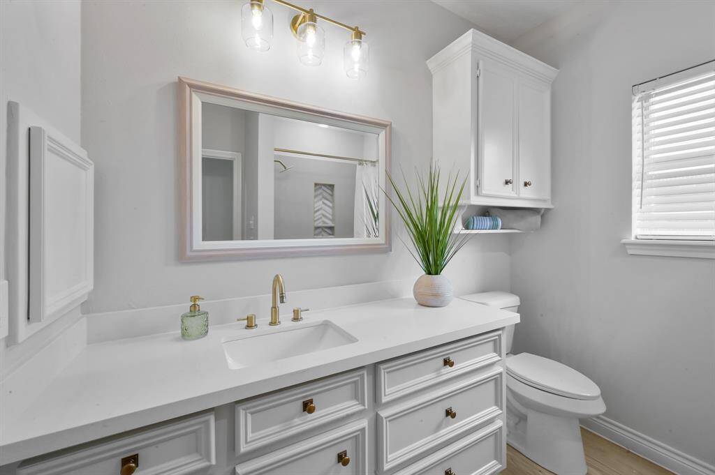 Charming half bath with new vanity. All bathrooms have new toilets.