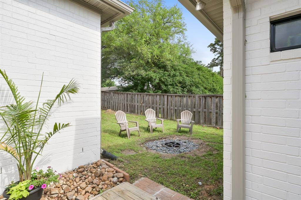 The custom home, shown from aerial perspectives, features a double driveway and a circle driveway. The residence is located on a corner lot in Twin Shores.