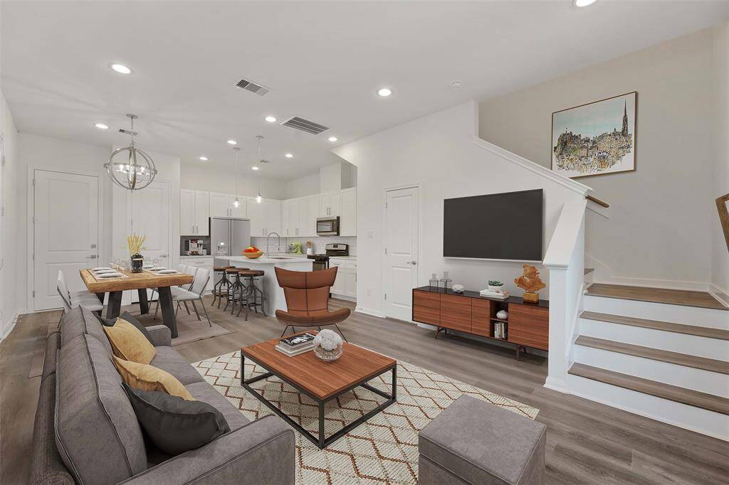 Bottom floor open concept living photo is virtually staged