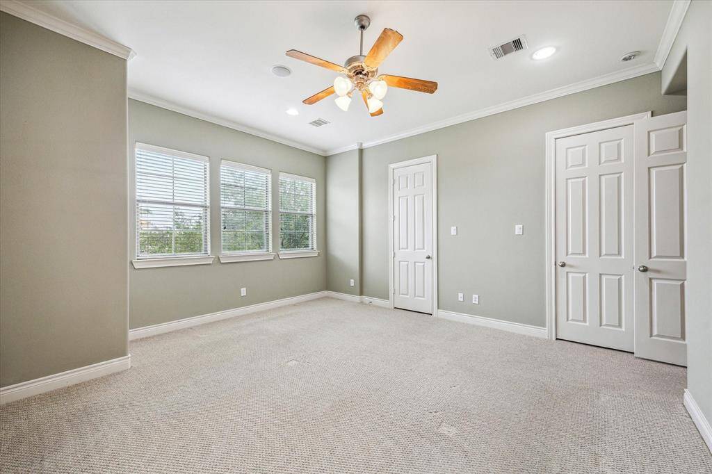 Another view of the primary bedroom and the two separate closets.