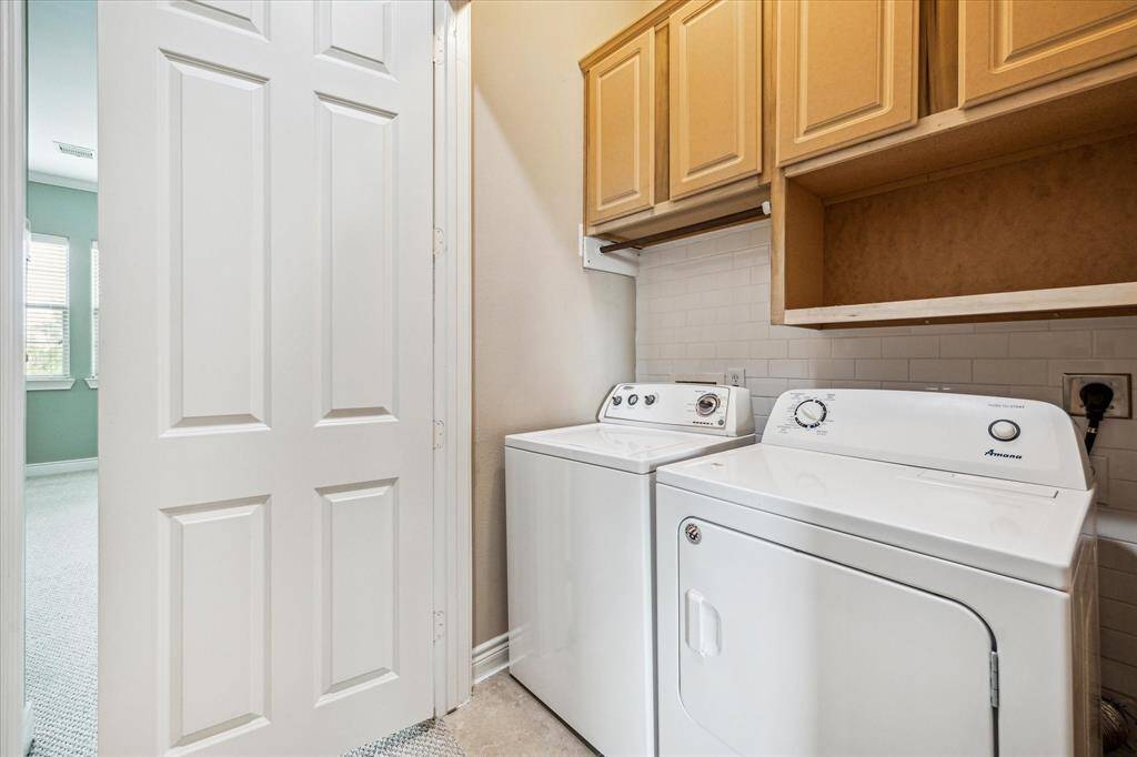 Convenient third-floor laundry closet featuring a stylish subway tile backsplash and upper cabinets that provide ample storage for all your laundry essentials—designed for both efficiency and ease.