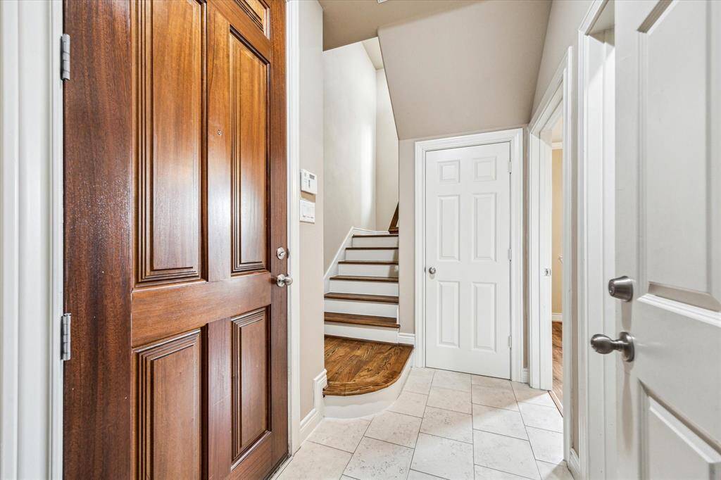 Upon entry, you're welcomed by an elegant natural palate. The staircase leads to the main living area. A private first-floor bedroom with en-suite bath is thoughtfully tucked away from the others—ideal for guests, a home office, or added privacy.