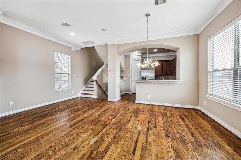 Arriving on the second floor, you’re welcomed into a bright and airy open-concept living, dining, and kitchen space—designed for effortless entertaining and inclusive living. Featuring rich wood floors, soaring ceilings, and an abundance of natural light, this vibrant main level is perfect for gatherings, celebrations, or everyday comfort. Beautiful and elegant crown molding throughout the home.