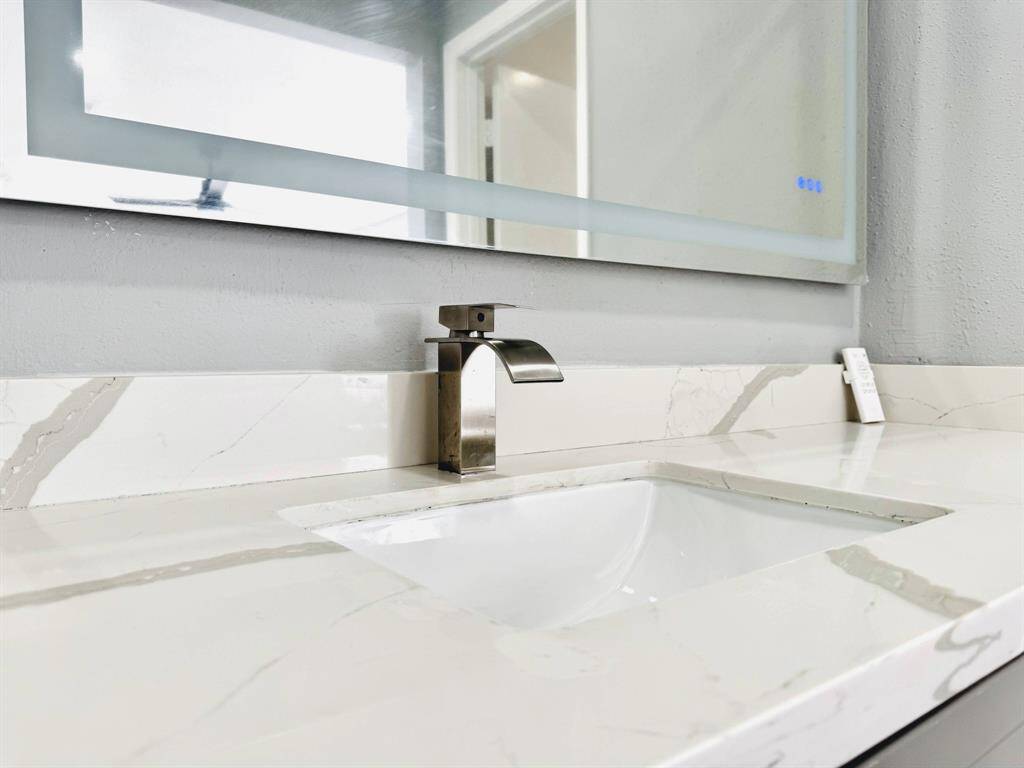Modern and sleek, this bathroom sink area combines style and functionality in a compact space.