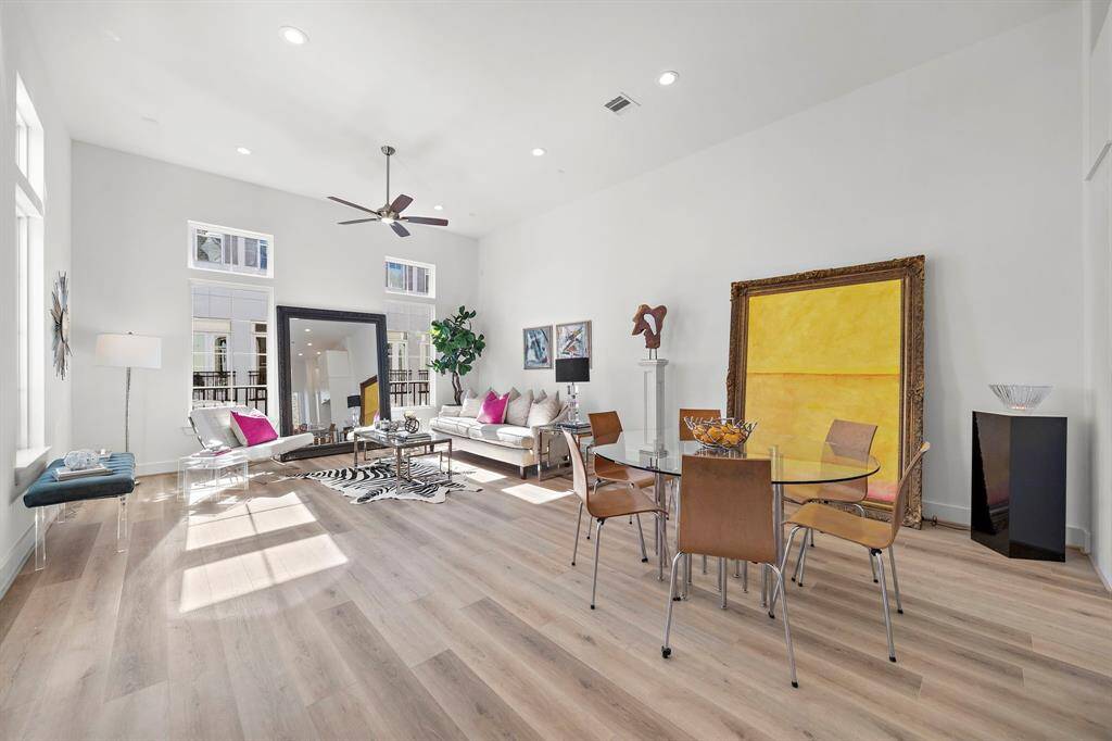 Spacious open, living/dining/Kitchen with 14 foot high ceilings, lots of windows, and gorgeous 7 inch vinyl hardwoods.