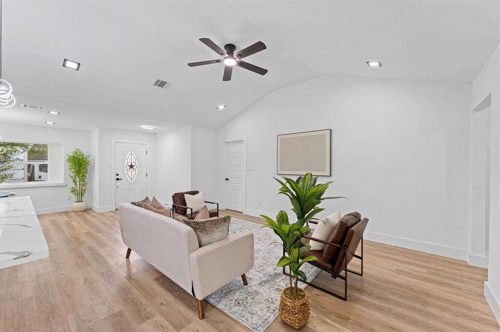 Spacious living area with fresh paint, new doors, new baseboards, new light fixtures and new flooring