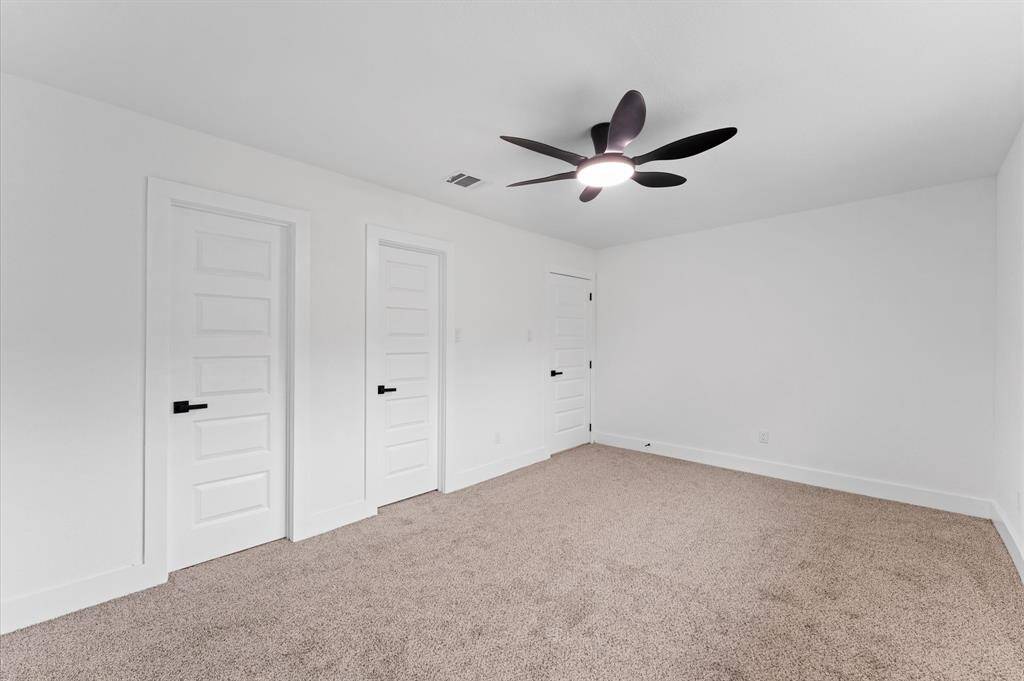 Primary bedroom with brand new carpet, new paint, new baseboards, new doors and light fixtures
