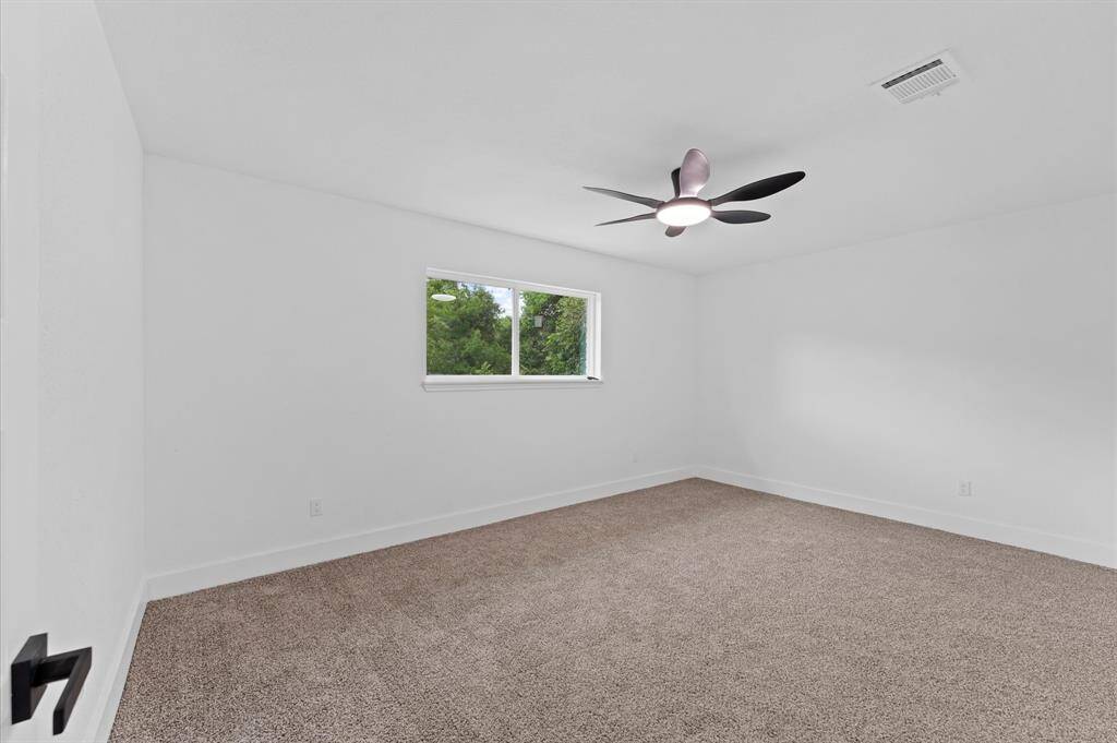 Primary bedroom with brand new carpet, new paint, new baseboards, new doors and light fixtures