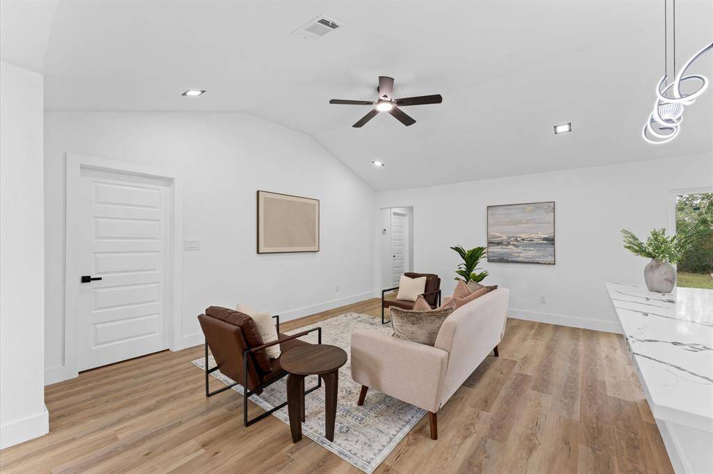 Spacious living area with fresh paint, new doors, new baseboards, new light fixtures and new flooring