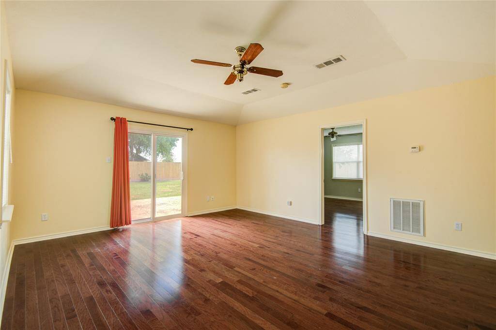 Bright family room with patio access and private entry to the downstairs primary bedroom suite.