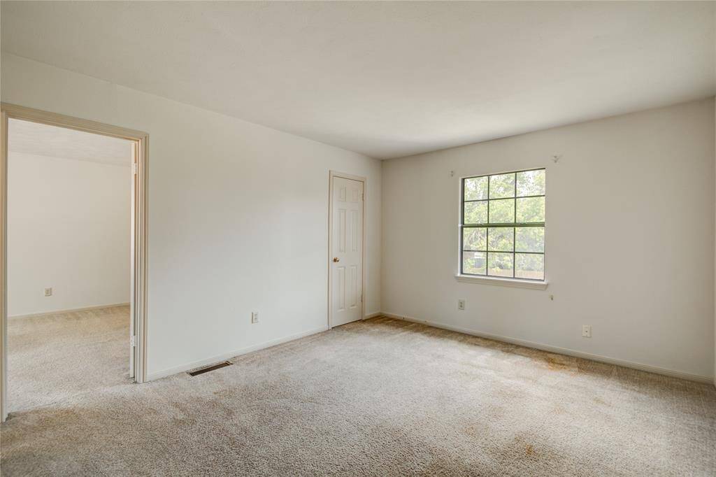 Spacious upstairs game room with backyard views and direct access to the upstairs primary suite, offering the perfect blend of relaxation and functionality.