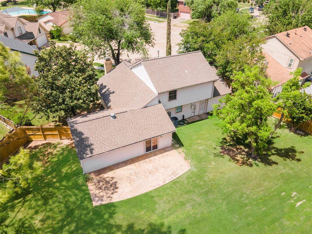 Bird’s-eye view reveals the home’s generous lot and concrete patio—perfect for entertaining.