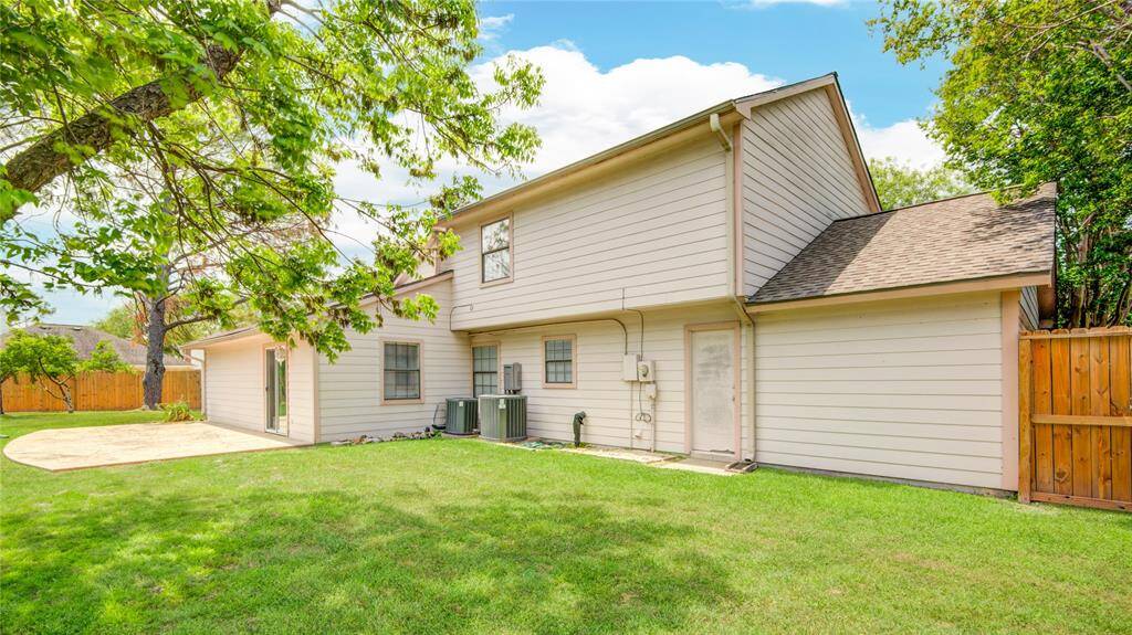 Expansive backyard with mature trees and plenty of room to play, garden, or relax.