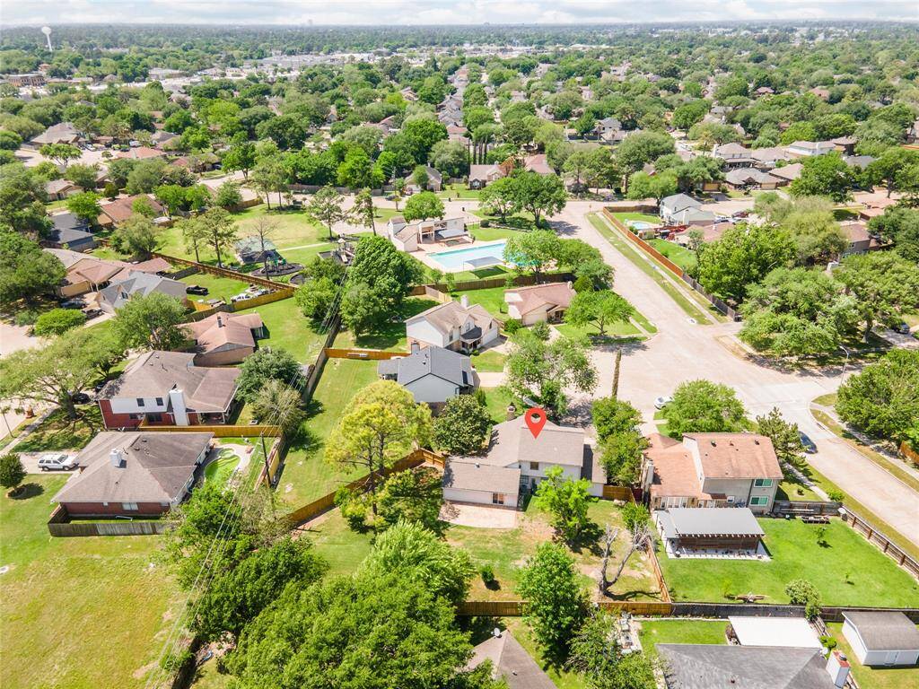 Aerial view of the home’s location within a peaceful, tree-lined neighborhood.