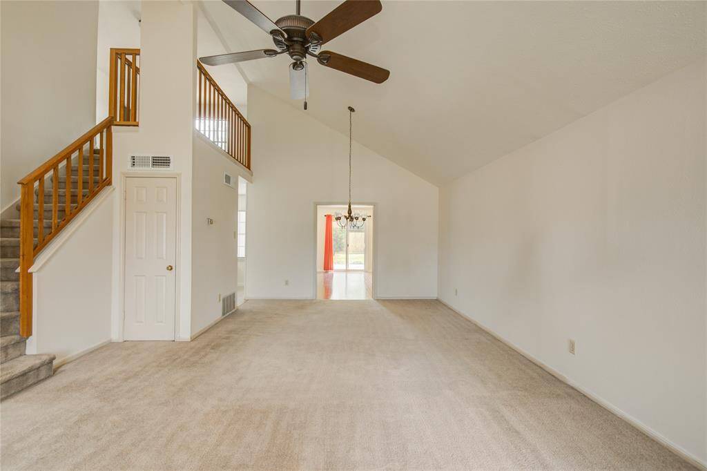 Vaulted ceilings and clean lines give this spacious living area an open, airy feel with seamless flow into the dining space.