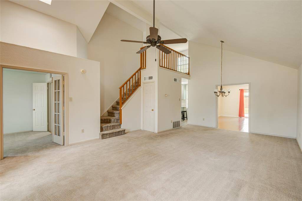 Just off the main living area, this versatile first-floor bedroom with French doors makes an ideal home office, guest room, or flex space.
